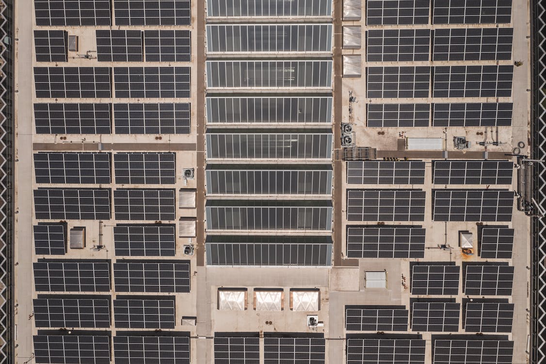Drone view of commercial rooftop solar panels